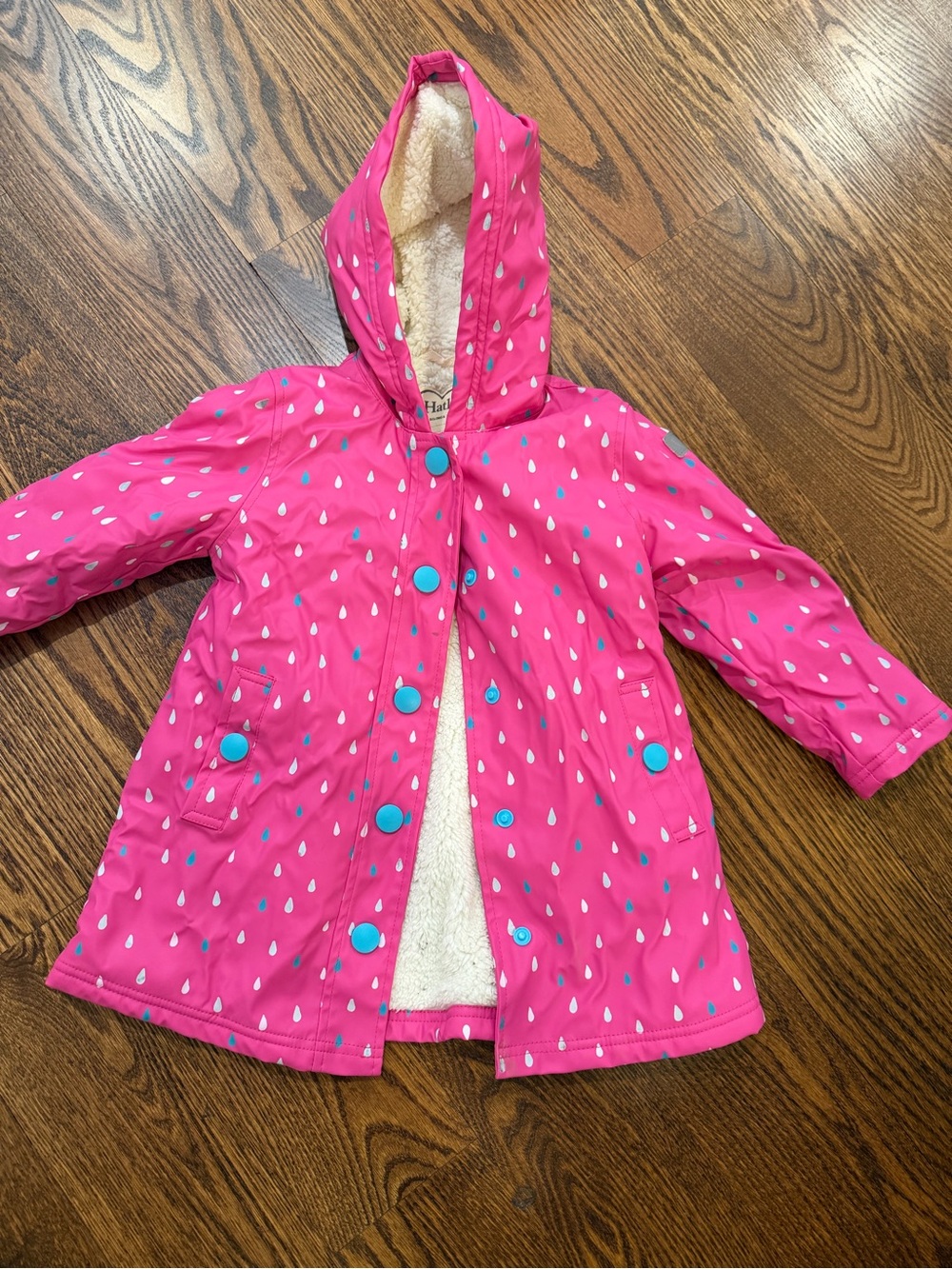 Hatley Bright Pink Hooded Raincoat with Blue Snap Accents